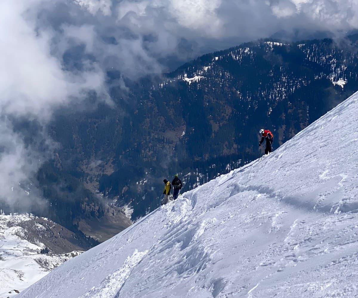 Skier descending a snowy slope in Gulmarg